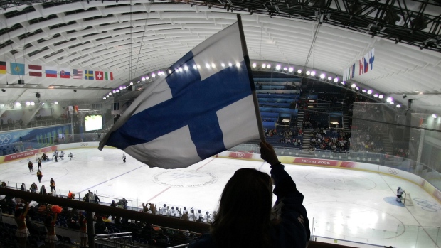 A hockey fan waves a Finnish flag