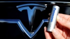 A Panasonic Corp's lithium-ion battery is pictured with the Tesla Motors logo