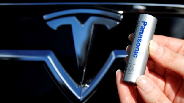 A Panasonic Corp's lithium-ion battery is pictured with the Tesla Motors logo