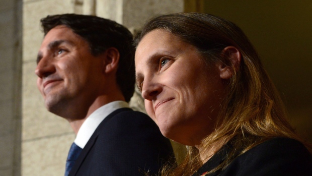 Prime Minister Justin Trudeau talks alongside Chrystia Freeland at a press conference