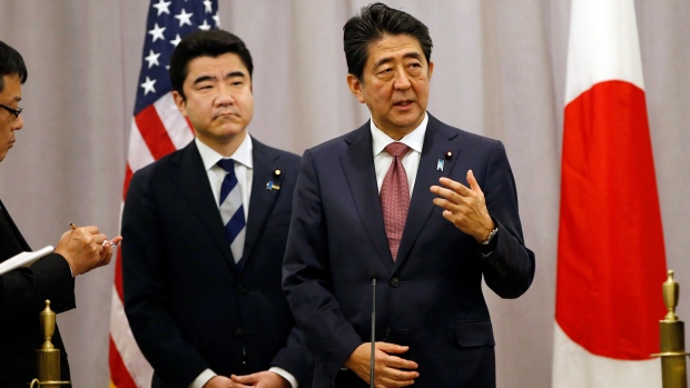 Japanese PM Shinzo Abe, right, answers questions after meeting with Trump on Nov. 17, 2016