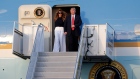 President Donald Trump and first lady Melania Trump step off of Air Force One
