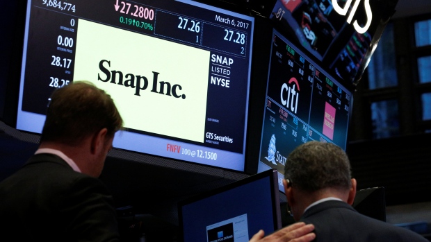 Traders gather at the post where Snap Inc. is traded on the floor of the New York Stock Exchange