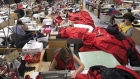 Workers piece together outerwear on the manufacturing floor of Canada Goose's facility in Toronto