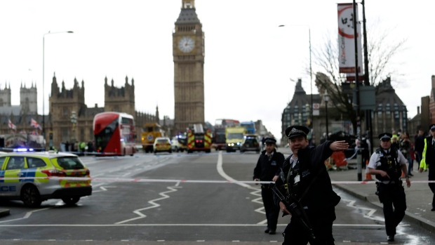 Police secure the area on the south side of Westminster Bridge close to the Houses of Parliament.  
