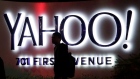 A person walks in front of a Yahoo sign at the company's headquarters in Sunnyvale, California