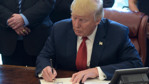 President Donald Trump signs an executive memorandum on investigation of steel imports on April 20