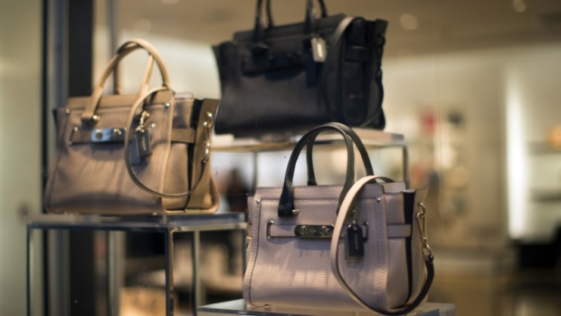Handbags are pictured through a window of a Coach store in Pasadena, California, January 26, 2015. 