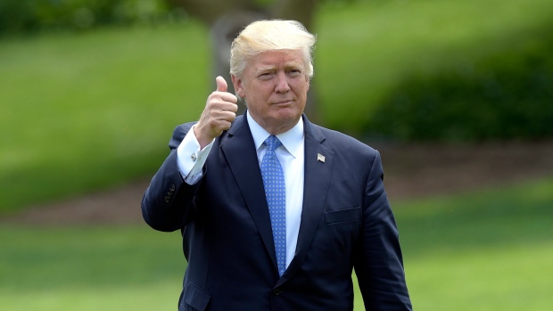 President Donald Trump gives a thumbs-up as he walks across the South Lawn of the White House