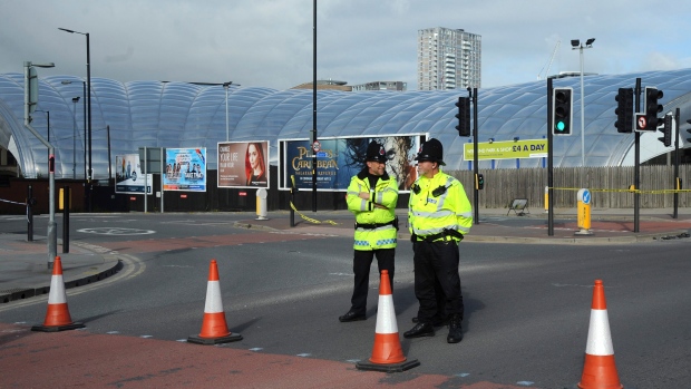 Police block a road outside the Manchester Arena in central Manchester, England Tuesday May 23, 2017