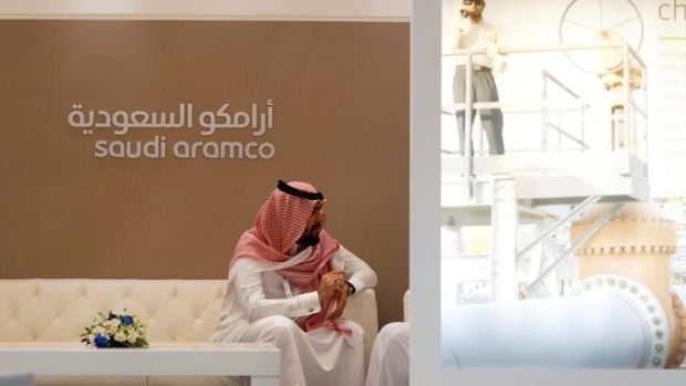 A Saudi Aramco employee sits in the area of its stand at the Middle East Petrotech 2016