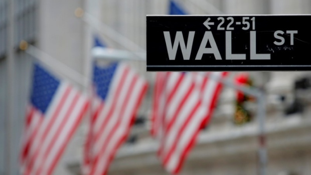 FILE PHOTO: A street sign for Wall Street is seen outside the New York Stock Exchange in New York City