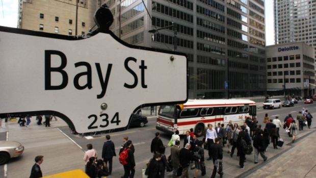 The Bay Street sign is pictured in the heart of the financial district as people walk by in Toronto
