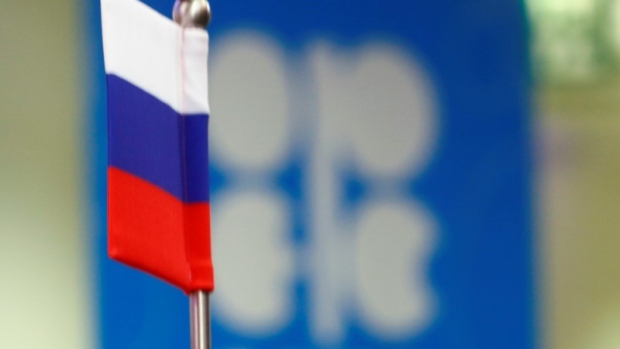 The Russian flag and the OPEC logo are seen before a news conference in Vienna, Austria