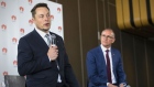 South Australian Premier Jay Weatherill (R) listens to Tesla Chief Executive Officer Elon Musk speak