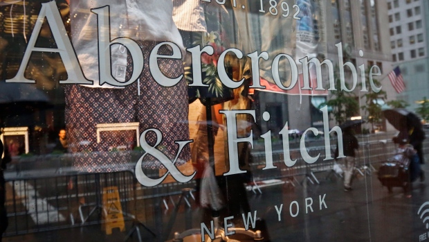 A store window reflects a street scene at an Abercrombie & Fitch