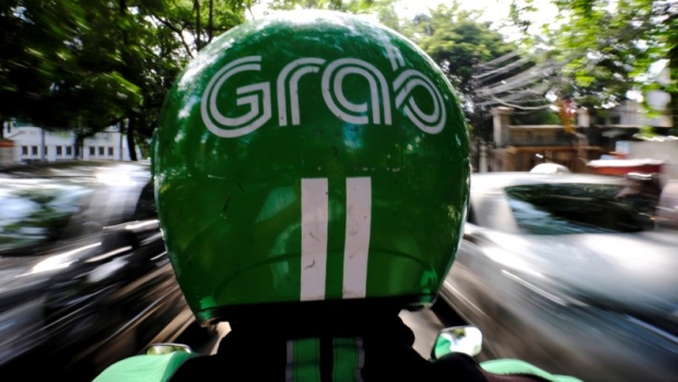 A Grab motor driver is seen in a street in Jakarta, Indonesia