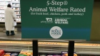 A sign explains animal treatment standards in the meat department at a Whole Foods Market