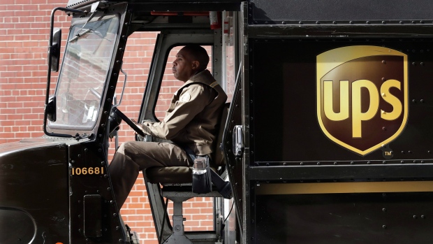 In this Tuesday, May 9, 2017, photo, a UPS driver takes his truck on a delivery route, in New York. 