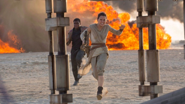 This photo provided by Disney/Lucasfilm shows Daisy Ridley, right, as Rey, and John Boyega as Finn, 