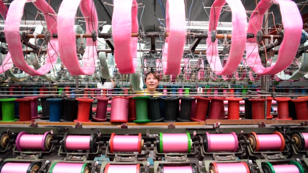 An employee works at a silk factory in Nantong, Jiangsu province, China July 17, 2017. 