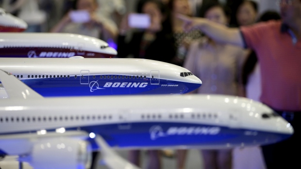 Visitors look at models of Boeing aircrafts at the Aviation Expo China 2015, in Beijing