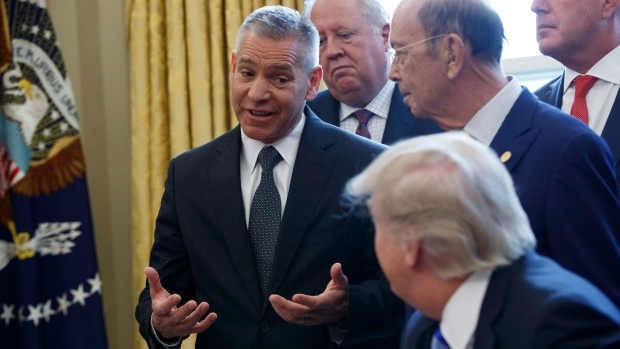 TransCanada CEO Russ Girling talks to Donald Trump after he signed his the Keystone XL permit
