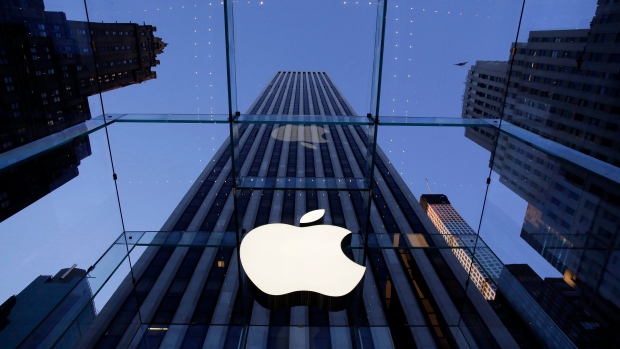 the Apple logo hangs in the glass box entrance to the company's Fifth Avenue store in New York. 
