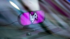 A Lyft Inc. light sits on the dashboard of a vehicle in the Time Square neighborhood of New York, U.S., on Wednesday, May 8, 2019. Jeenah Moon/Bloomberg
