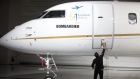 An employee opens the door on a Bombardier jet in Montreal, Quebec.