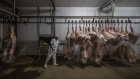A worker moves cattle carcasses at the municipal slaughterhouse in Sao Felix do Xingu, Para state, Brazil.