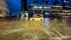 A taxi navigates floodwaters in Dubai. Photographer: Giuseppe Cacace/AFP/Getty Images