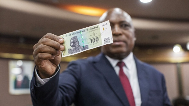 Mushayavanhu holds up a ZiG note at a news conference in Harare, on April 5.