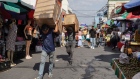 <p>Shoppers at a street market in San Salvador, El Salvador.</p>