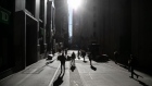 Pedestrians walk along Wall Street in New York. Photographer: Michael Nagle/Bloomberg