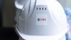 Logo for UBS Group AG on a helmet during a topping out ceremony for UBS' new office building in Hong Kong, China, on Wednesday, March 27, 2024. UBS will lease an entire 14-story office tower in Hong Kong — almost double the space it initially planned — helping provide a vote of confidence for a city battling to keep its status as the region's premier financial hub. Photographer: Chan Long Hei/Bloomberg