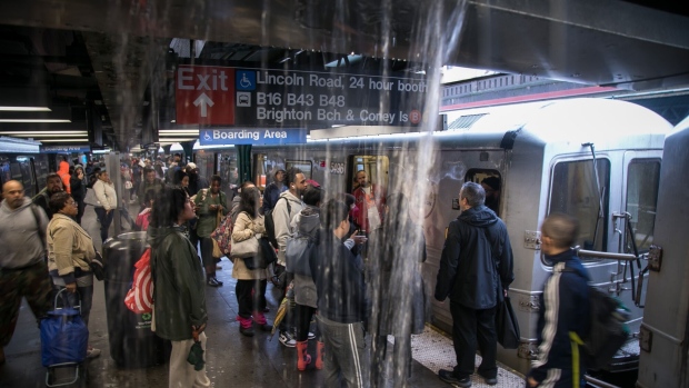 <p>Commuters wait at a subway station during a rain storm in Brooklyn, on Sept. 29. 2023.</p>