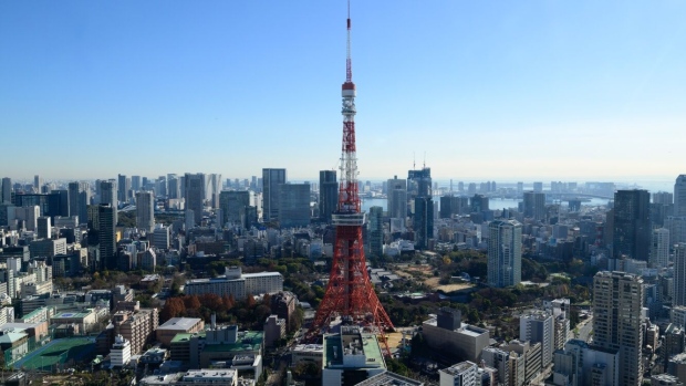 The Tokyo Tower, center, and commercial and residential buildings in Tokyo, Japan, on Tuesday, Dec. 26, 2023. Japan’s industrial output in November is scheduled to be released by the Ministry of Economy, Trade and Industry on Dec. 28. Photographer: Akio Kon/Bloomberg