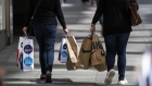 <p>Pedestrians carry shopping bags in San Francisco.</p>