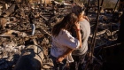 <p>A resident observes the remains of her home during the Highland Fire in Aguanga, California.</p>