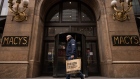 A shopper carries a Paragon Sports bag past Macy’s flagship store in the Herald Square neighborhood of New York, US, on Thursday, April 11, 2024. 