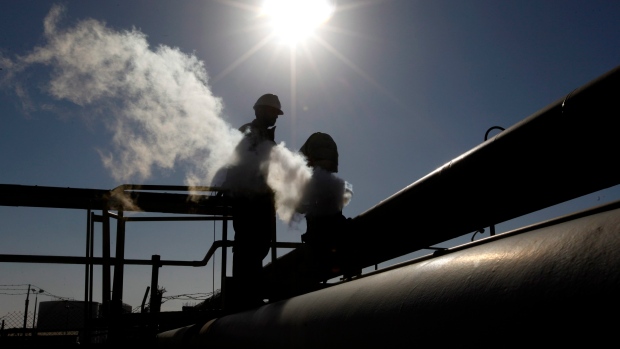 In this file photo, a Libyan oil worker works at a refinery inside the Brega oil complex, in Brega, 