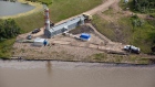 Husky crews work to clean up an oil spill on the North Saskatchewan river near Maidstone, Sask