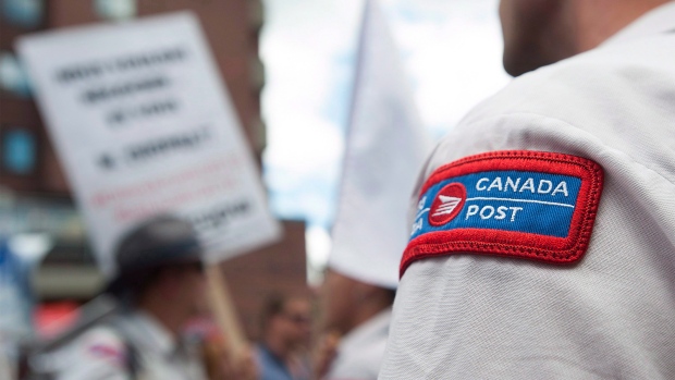 Canada Post workers demonstrate outside the riding office of Prime Minister Justin Trudeau