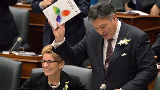 Ontario Finance Minister Charles Sousa, right, delivers the budget next to Premier Kathleen Wynne