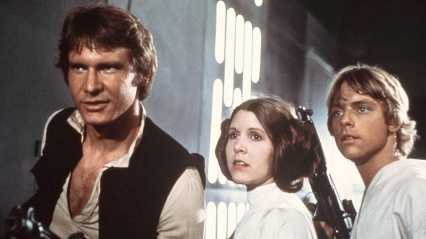 Harrison Ford, Carrie Fisher, and Mark Hamill are shown in a scene from "Star Wars"
