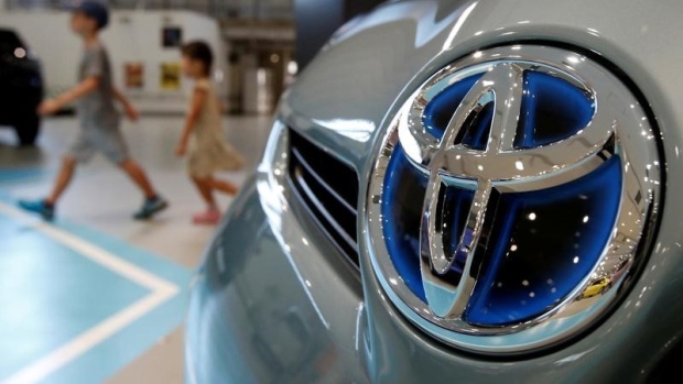 A logo of Toyota Motor Corp on a Toyota Prius hybrid vehicle at the company's showroom in Tokyo