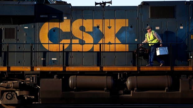 A crew member walks on a CSX freight train engine in Brunswick, Md. 