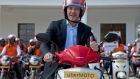Travis Kalanick poses during the launch of Uber's bike-sharing product, uberMOTO