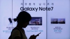 A woman walks by an advertisement of Samsung Electronics' Galaxy Note 7 smartphone
